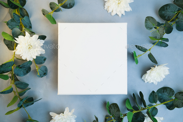 Blank canvas frame white flowers and plant branches. Stock Photo